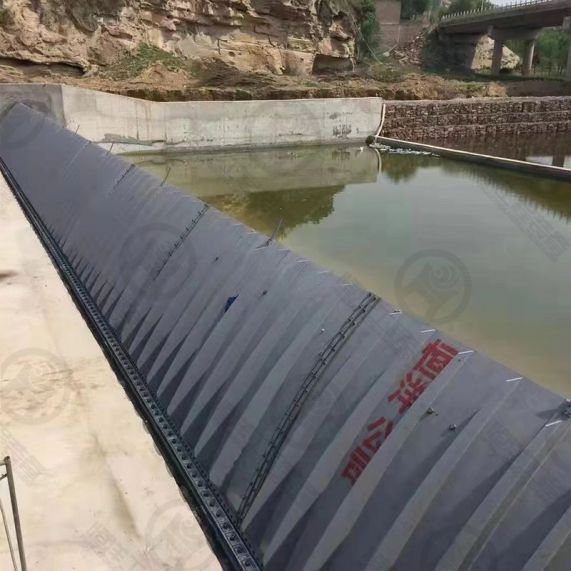 ​Shield type rubber dam, also named pneumatic shield type rubber dam, is a new kind of rubber dam integrating the advantages of traditional steel dam and rubber dam. It consists of civil part, embedded components, shield plates, air bladders, pneumatic charging and discharging system. Steel shield plates provide front stop water; rubber air bladders provide support for shield plate; a row of basic anchor bolt and soft connection construct the whole structure of dam